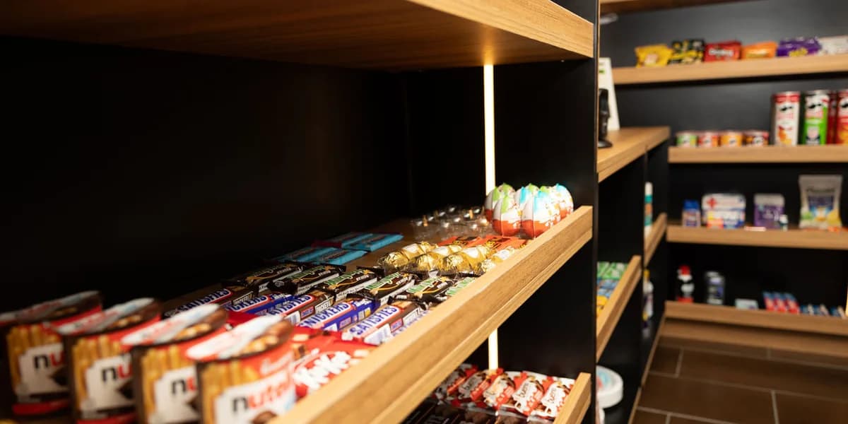 Chocolate bars and candy on lit wood shelves at The SmAll Market