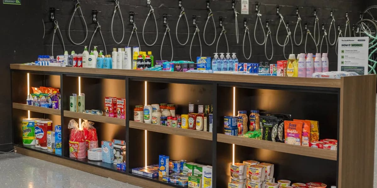 Personal care, household essentials and pantry staples on lit shelves at The SmAll Market