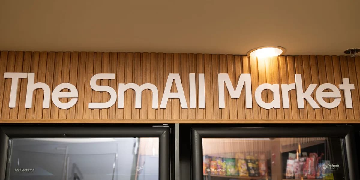 The SmAll Market sign above refrigerated coolers inside a residential building
